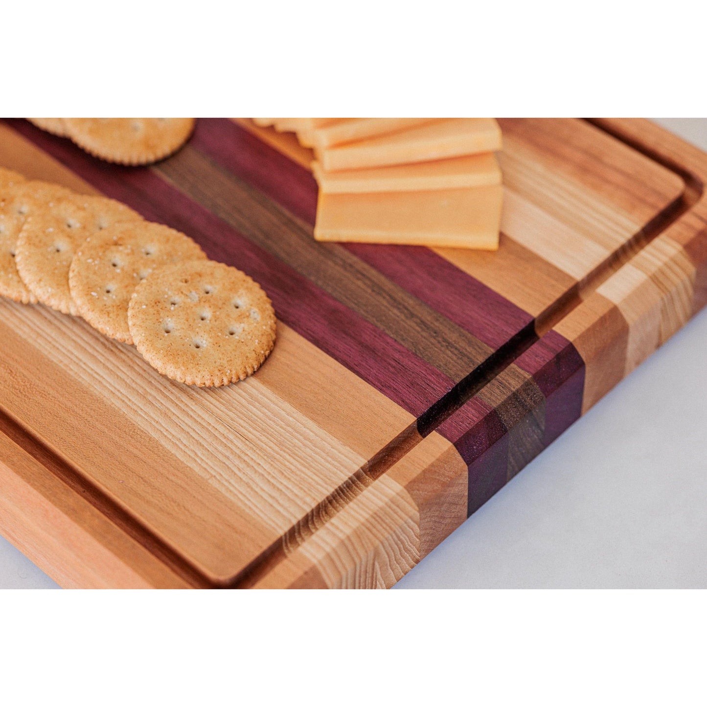 Large Hardwood cutting board with juice groove! Walnut, purple heart, hickory, hard maple, and cherry. Approx 17"x10.5"x1.5"