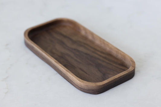 Delight your husband or boyfriend with our hardwood valet tray, a walnut catch-all tray that serves as a wooden desk organizer. This Christmas, surprise them with this approximate 5"x10"x3/4" gift, designed to keep their essentials organized in style.