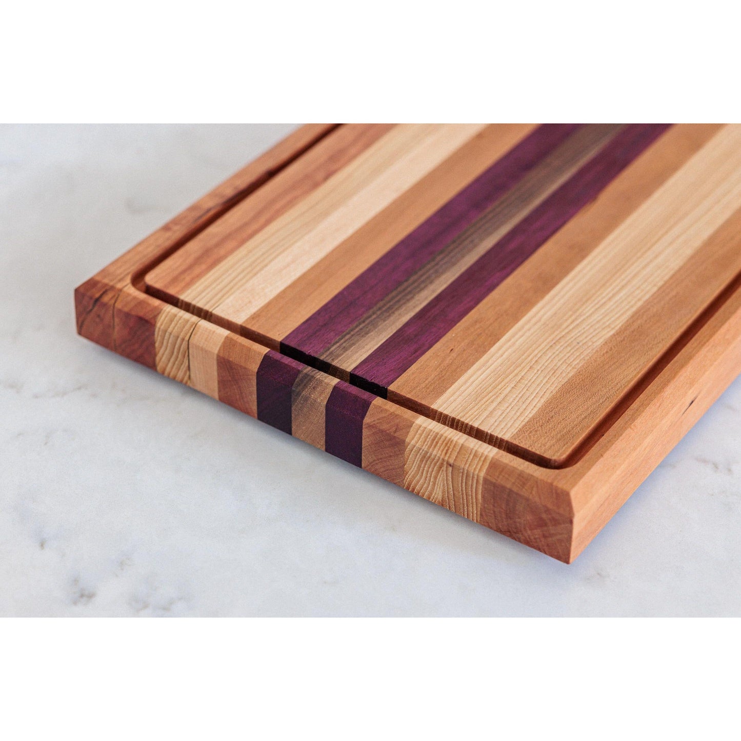 Large Hardwood cutting board with juice groove! Walnut, purple heart, hickory, hard maple, and cherry. Approx 17"x10.5"x1.5"