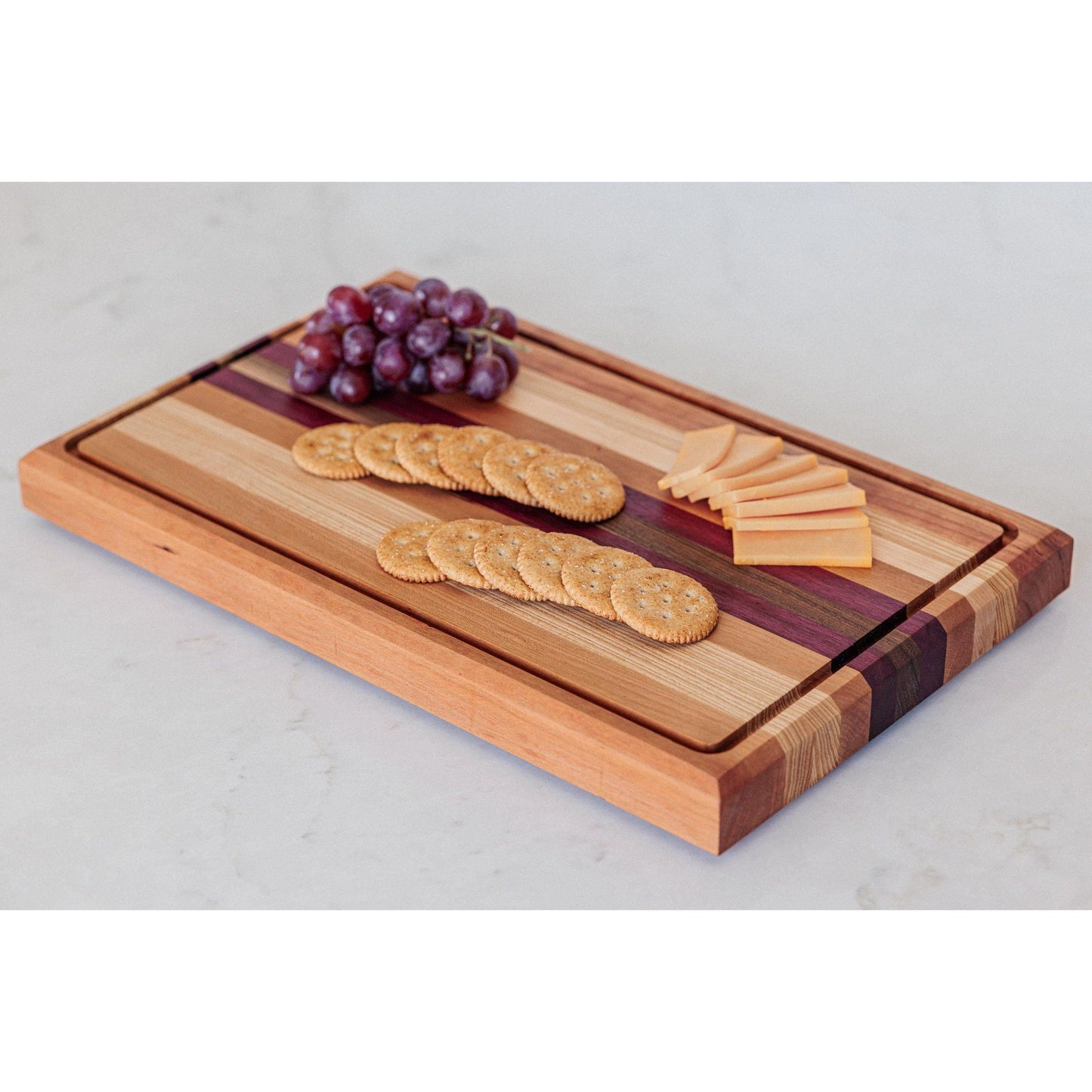 Large Hardwood cutting board with juice groove! Walnut, purple heart, hickory, hard maple, and cherry. Approx 17"x10.5"x1.5"