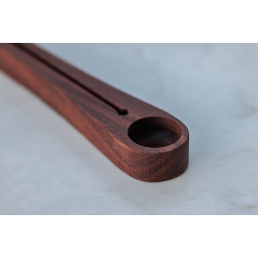 Walnut coffee scoop and bag sealer. This versatile tool allows you to measure the perfect amount of coffee and securely seal the bag for freshness. Crafted from walnut, it adds a touch of elegance to your coffee routine.