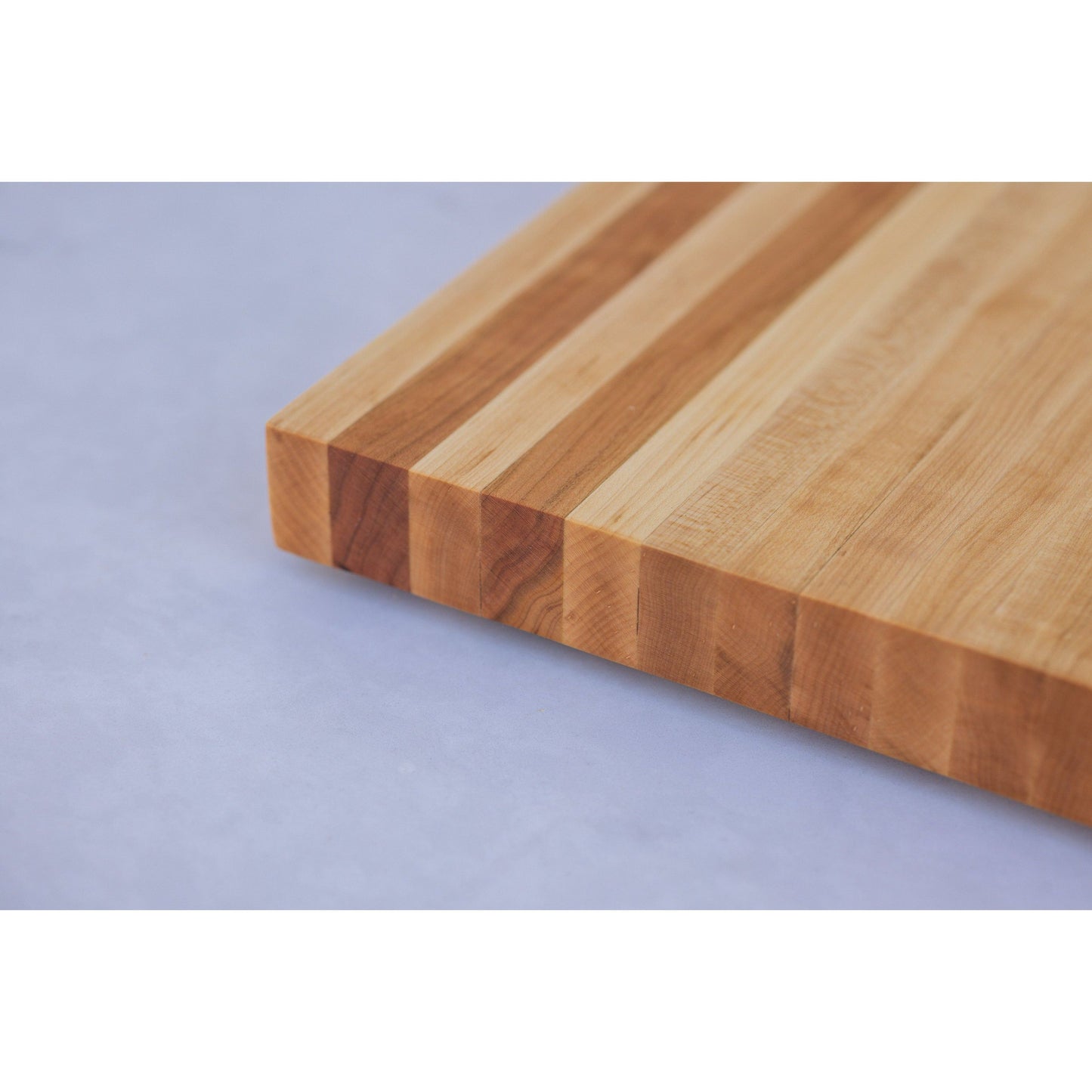 Experience the allure of our large hardwood cutting board. Expertly crafted from hard maple and hickory, this exquisite gift measures approximately 17"x10.5"x1.5". Combining beauty and functionality, it's the perfect present for culinary adventurers.