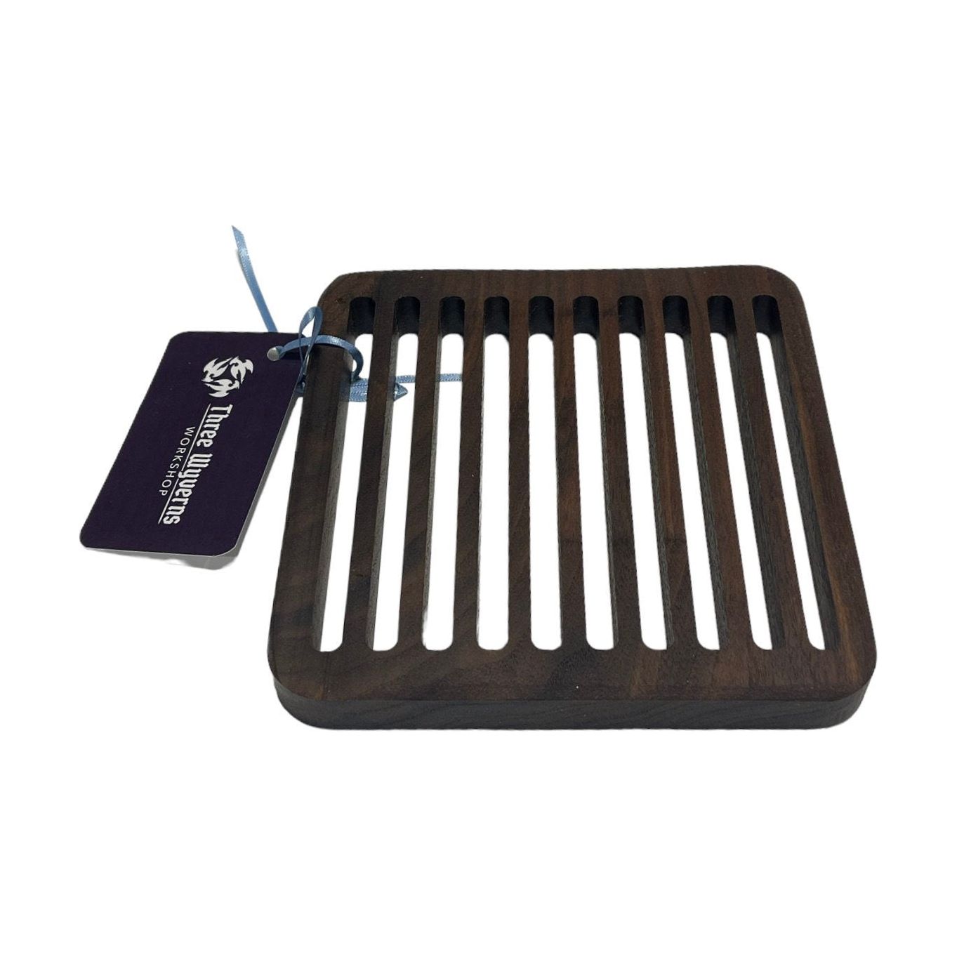 Elevate your dining experience with our Black Walnut Trivet. Handcrafted and timeless, it adds warmth and sophistication to your table. Protects surfaces from heat and serves as a beautiful centerpiece. Measures 6.5" x 6.5" x .75"